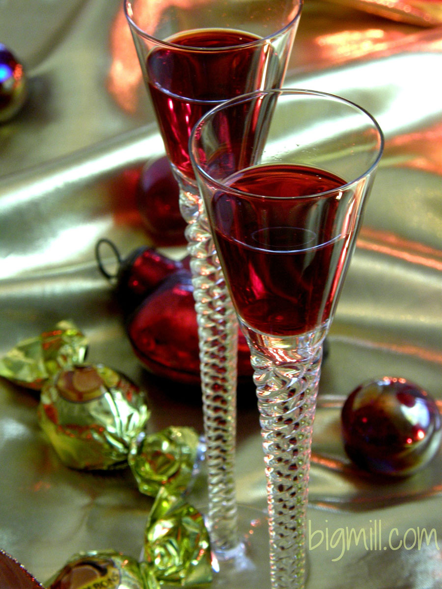 Festive, colorful Homemade Cranberry Liqueur is a hit at all your holiday parties. Recipe from Chloe at Big Mill | bigmill.com